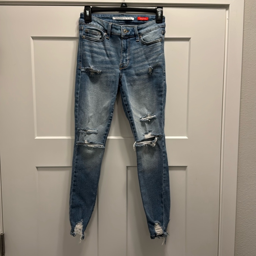 Celebrity Pink Jeans Size 1/25, ripped at the knees, bottom of legs, skinny.
